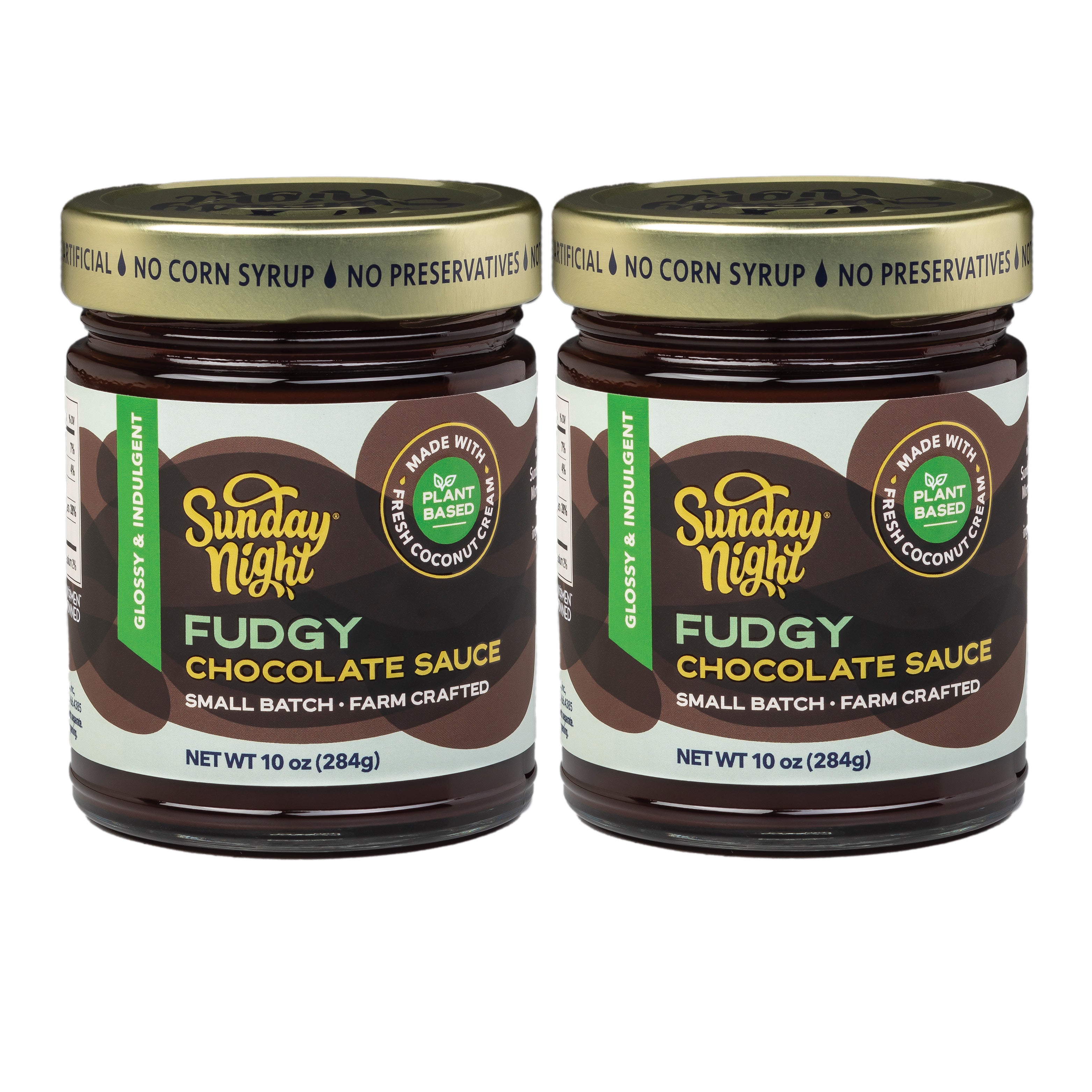 Two jars of Sunday Night Fudgy Chocolate Sauce on a white background