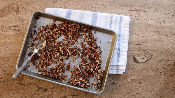 Sunday Night® Salted, Buttered Pecans displayed on a baking pan